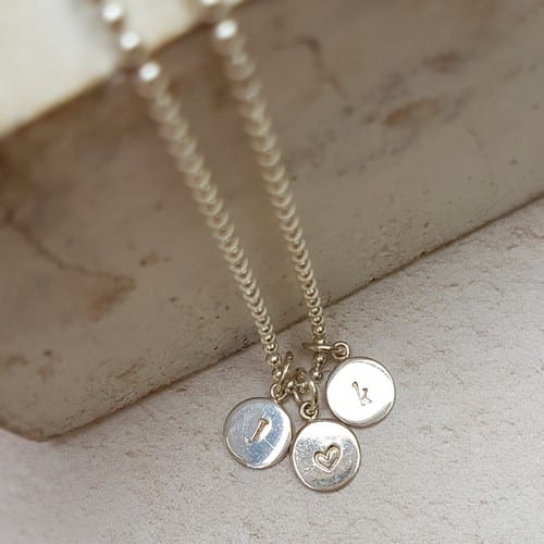 hand stamped personalised initial charm sterling silver