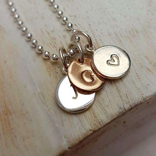 hand stamped personalised initial charm sterling silver